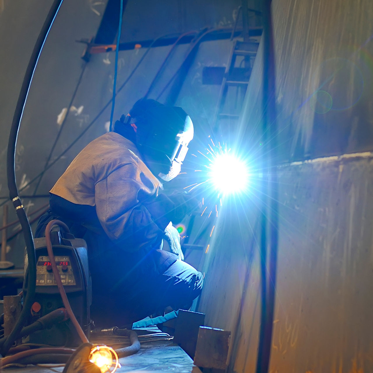 a welder working at shipyard in day time